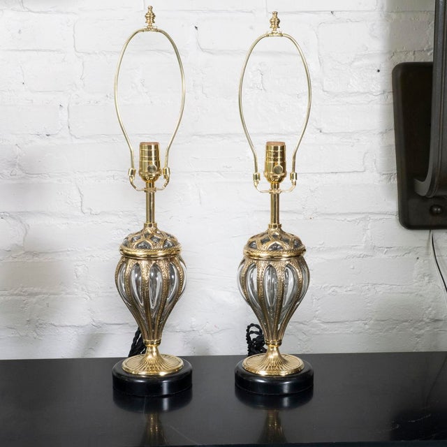Pair of blown glass table lamps in cast brass cage.