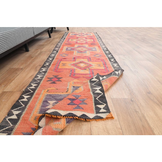 Vintage Hand-Knotted runner rug is a semi-antique vintage area rug. The '70s Eastern region of Anatolia's unique rug is...