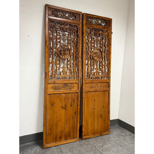 Design Plus Gallery presents a Pair of Vintage Chinese Carved Wood Divider Panels. This two-panel set has ornately carved...