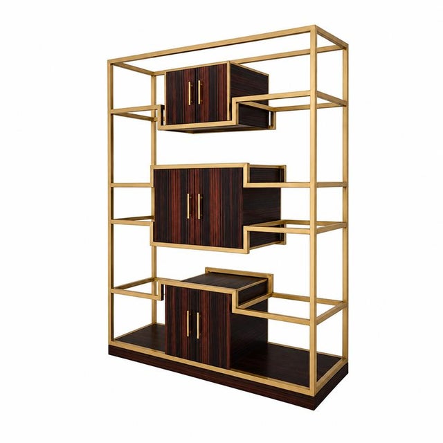 Bookcase with tubular brass structure, enriched by three wooden compartments with two doors. Dimensions (wxdxh) 170 x 60 x...