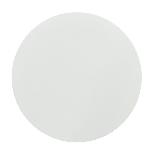 A weighted base supports the three sculptural legs that flair to the brushed oak top.