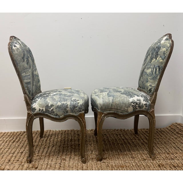 Pair of Louis XV period flat-back chairs in molded, carved and waxed beech wood. enhanced with symmetrical carvings such...