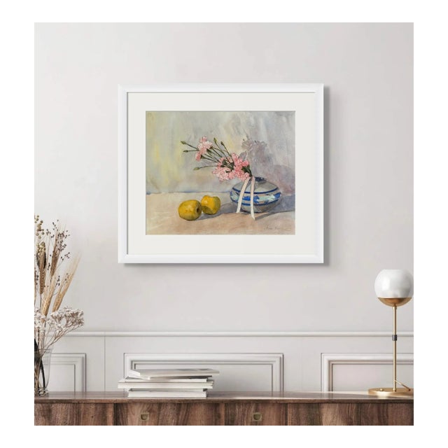 This still life combines the soft pink of carnation flowers with the vivid spirit of yellow-green apples, all arranged on...