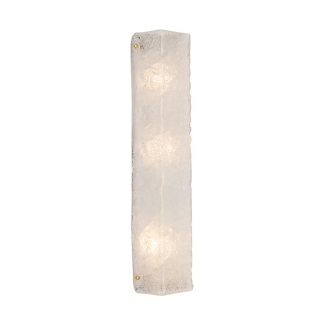A striking Italian wall sconce featuring a long, substantial panel of hand-worked Murano glass with a beautifully textured...