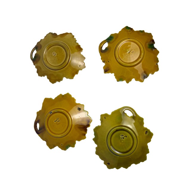 A lovely set of four antique majolica leaf dishes attributed to Villeroy & Boch, featuring a raised‑relief leaf design in...