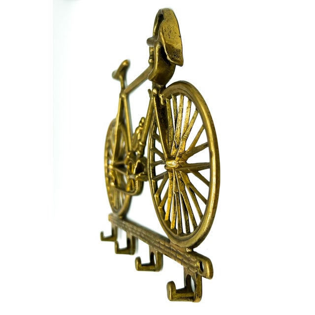 Whimsical vintage solid brass wall-mounted hook rack in the shape of a classic racing bicycle. Featuring fine details...