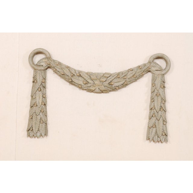 A vintage carved and painted wood swag. This carved wood architectural ornament features two circular rings at either far...