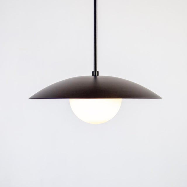 The Dome Pendant Light floats — a well-proportioned fixture that couples a glass orb with powder coated steel. It’s...
