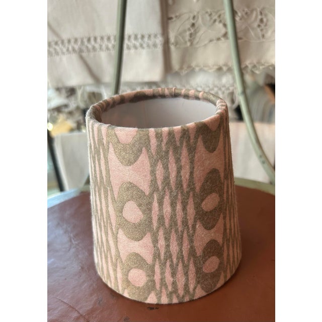 A clip top chandelier shade made from Fortuny’s iconic UNITA pattern printed fabric, measurements: top 3” side 4” bottom...