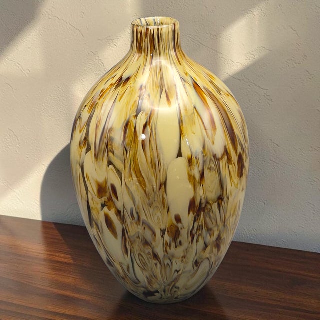 This vintage hand-blown art glass vase in a brown and cream tortoise-style design stands at 13 inches tall. Made in Italy,...