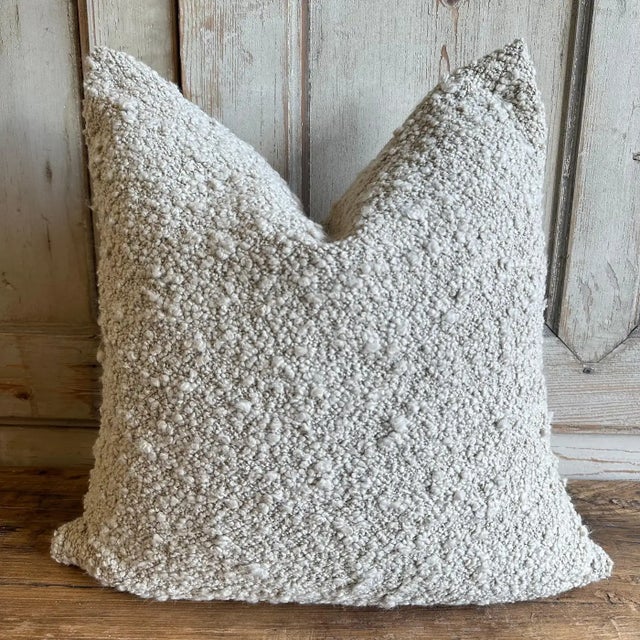 Woven in belgium using traditional weaving techniques, and features a soft boucle yarn on cotton warp. Zipper closure....