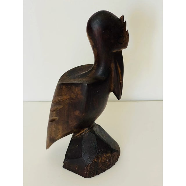 Vintage handcarved of tropical wood sculpture Pelican on rocks. Coastal Safari style decor.