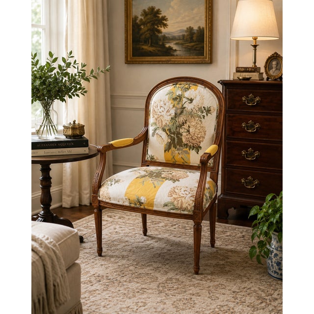 Elegant Louis XVI style fauteuil armchair featuring a carved walnut frame with fluted legs, scrolling arms, and...