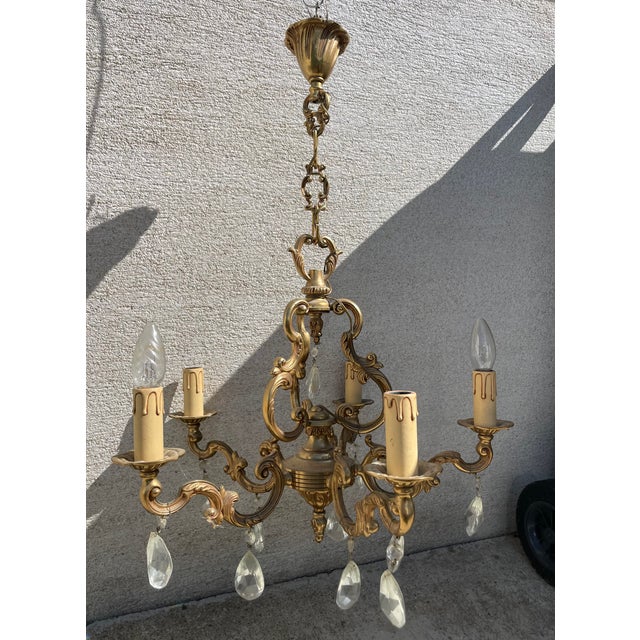 Two Louis XV style brass chandeliers 5 and 6 branches. First chandelier dimension width 60, depth 60, height 65. Second...