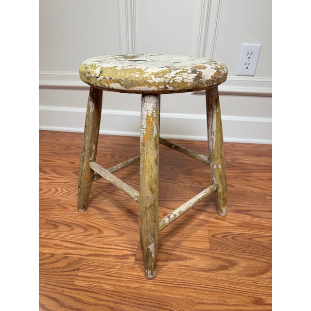 This is a simple, backless, round and low antique wooden stool. Often referred to as a "milking stool" or "farm stool". It...
