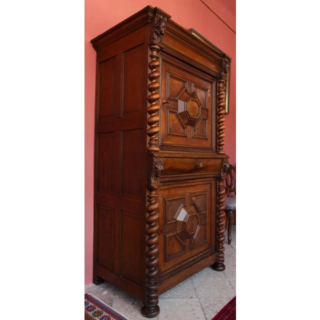 Baroque two-door wardrobe made of solid oak, dating from around 1770. This is a distinctive piece of historical furniture...