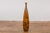 A tall two-tone brown vase with textured accents. This contemporary tall two-tone brown vase is a delicate fusion of...