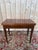 A Louis XVI-Directoire style folding games table in solid mahogany, early 19th century. The rectangular top unfolds to...