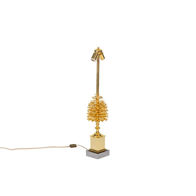 Lamp in gilded bronze representing a pine cone standing on a gilded and silvered bronze base. This piece is designed in...