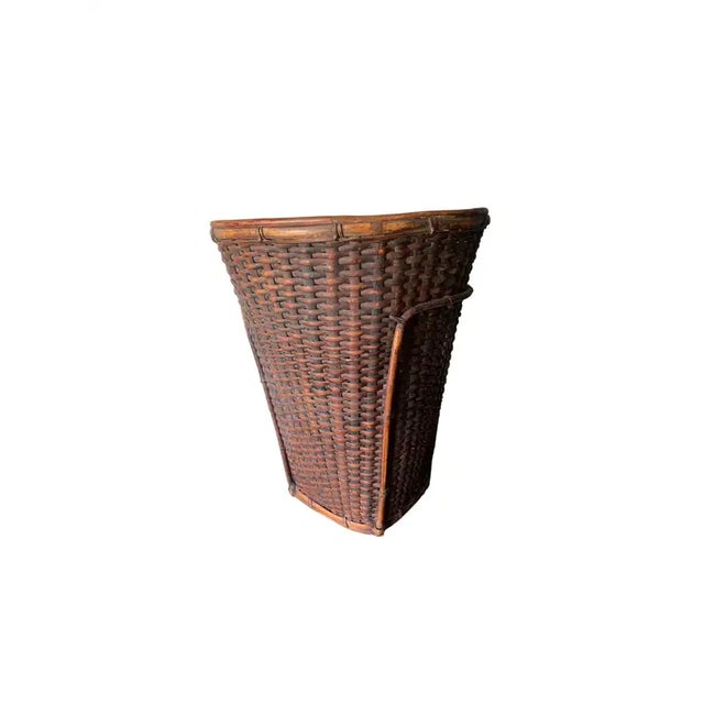 This mid-20th century hand-woven basket originates from the Dayak tribe of Borneo crafted with rattan fibres. These...