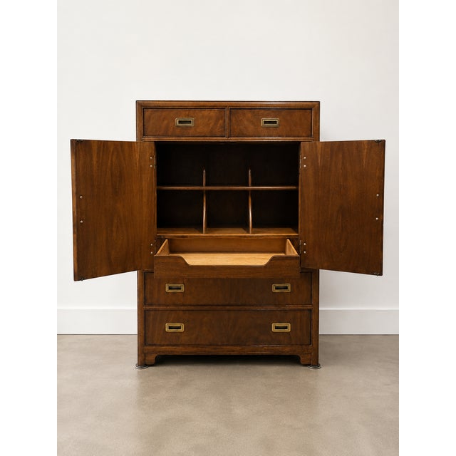 A beautifully made campaign-style cabinet from Drexel Heritage, showcasing rich burl grain and warm honey tones. Solid...