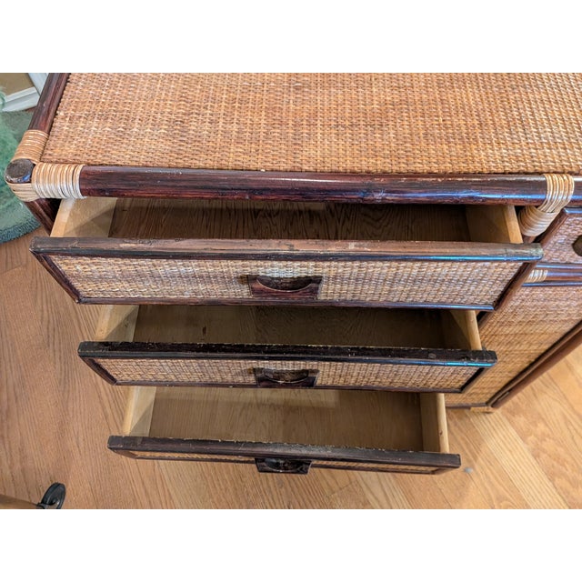 Vintage rattan and bamboo storage cabinet sourced in Japan, featuring a richly toned bent bamboo frame with handwoven...