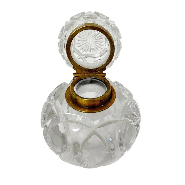 A Baccarat style crystal inkwell with decorated bronze. Circa 19th century, France. The interior is two inches deep and...