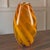 This Mid-Century Modern hand-blown cased glass vase features a warm amber and white ribbon design, measuring 14.5 inches...