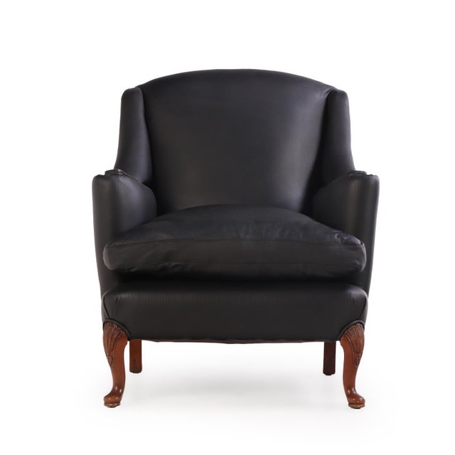 A handsome pair of club chairs dating to circa 1950, newly upholstered in rich leather and distinguished by their timeless...