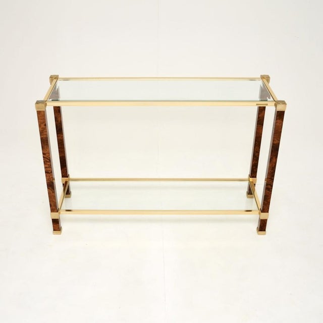 A stunning vintage French walnut and brass console table by Pierre Vandel Paris. This was made in France, it dates from...
