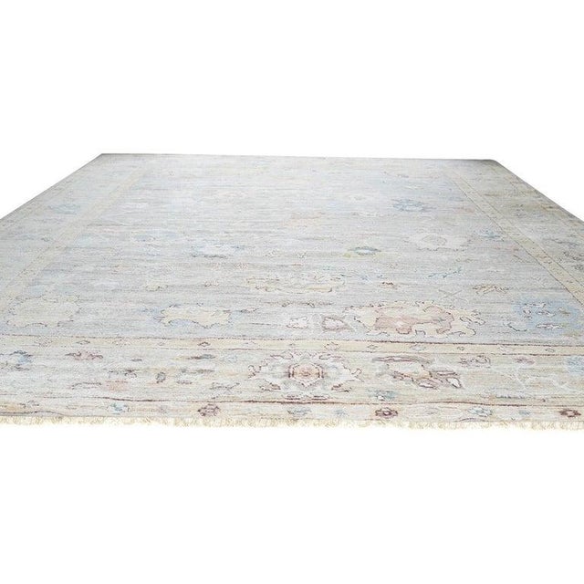 This hand knotted pile rug features a classic traditional design rendered in a primary color palette of ivory, beige,...