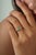 This dainty ring features a 0.5 carat oval-cut emerald set in 14K yellow gold. The emerald measuring 4 x 5.8 mm, elegantly...