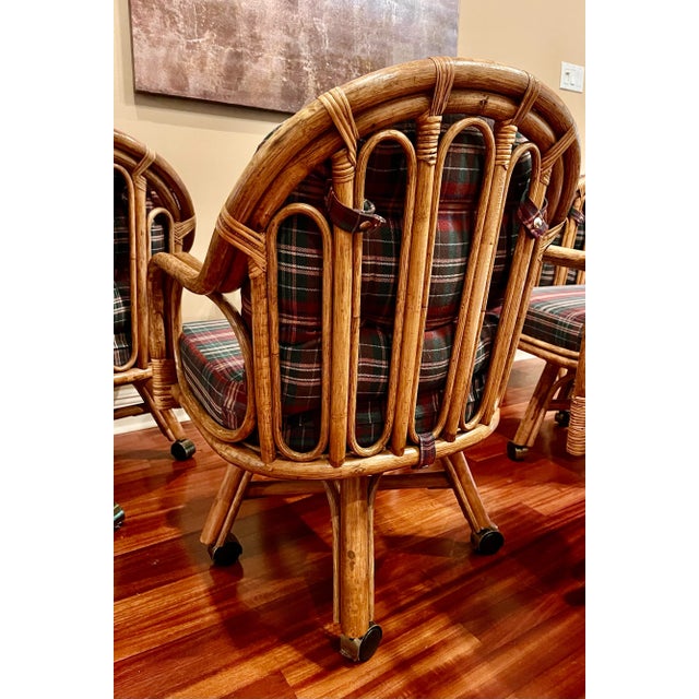Fun set of rattan dining chairs showing very little wear. The finish on the rattan is not worn and the protective plastic...
