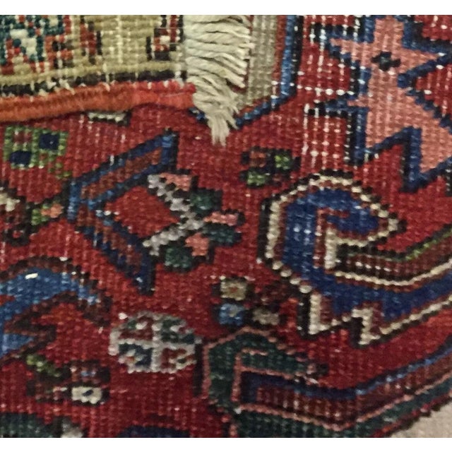 This handwoven wool Heriz rug, crafted around 1930, showcases a traditional design that embodies the rich heritage of rug...