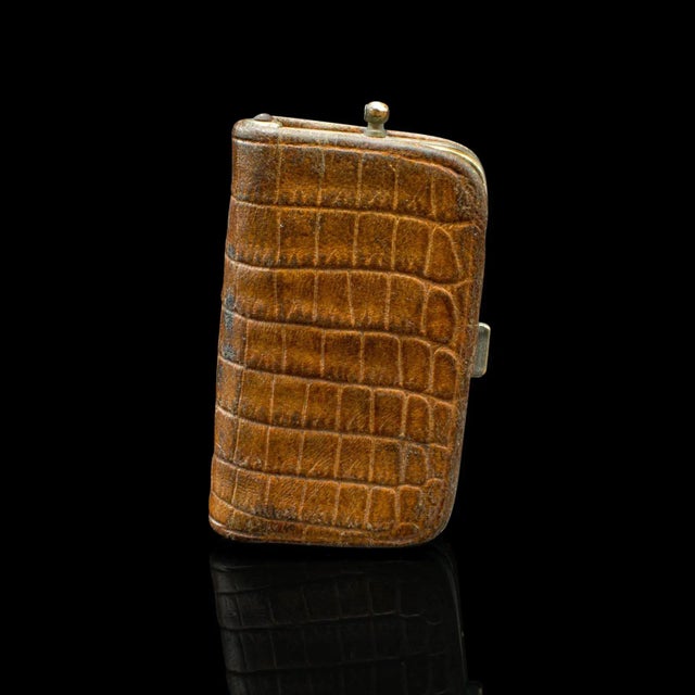 This is an antique gentleman’s money clip. A German, leather and silver plated pocket coin holder, dating to the Edwardian...