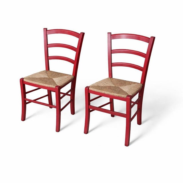 pair of Italian ladderback dining chairs crafted in solid oak and finished in a rich, deep red tone. These chairs combine...