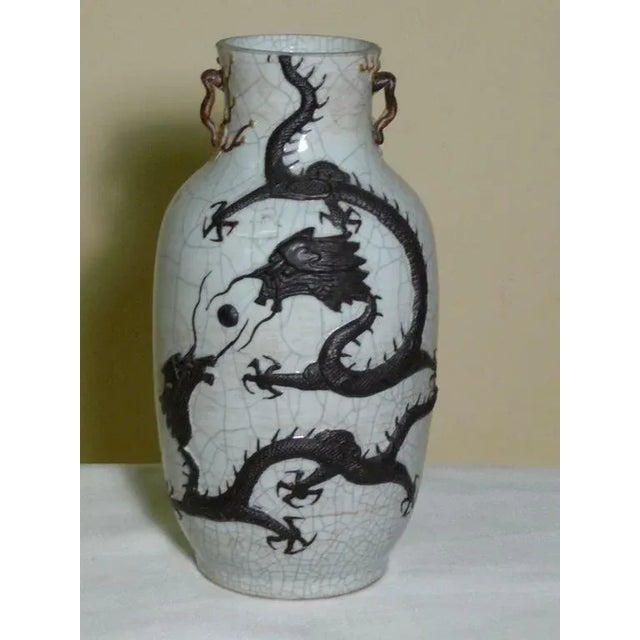 Chinese Qing Dynasty circa 1875 large baluster form stoneware vase, celadon crackle glaze finish with high relief iron...