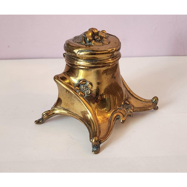 This is a great little antique Art-Nouveau style 1930s brass inkwell made by Jennings Bros. Marked on bottom JB & 117....