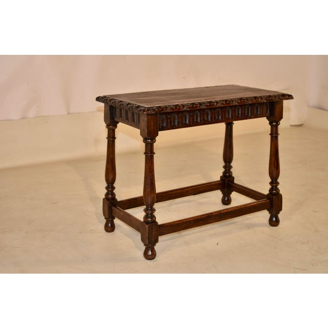 Late 19th century hand carved and turned oak stool from England. The top has lovely graining and is surrounded by a...