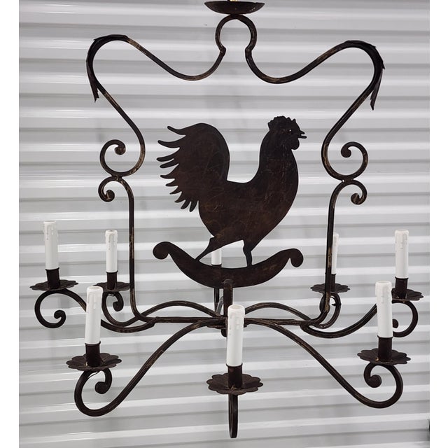 Mid Century French country style wrought iron rooster chandelier with eight lights. Featuring a central motif of a rooster...
