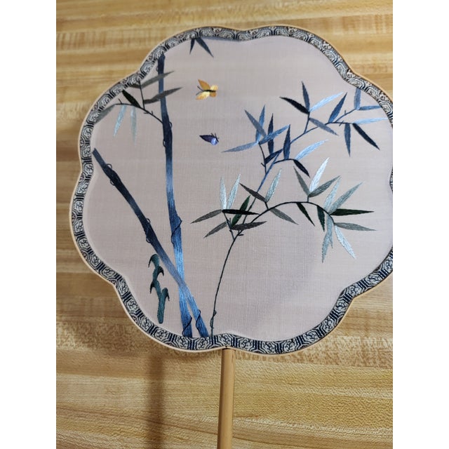 Striking embroidered botanical scene on silk depicting bamboo and butterflies. The stitches show a great variety of...