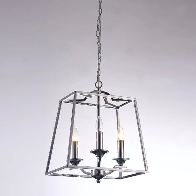 The Lionnel chandelier features a polished chrome frame with three lights designed to resemble classic table candles. Part...