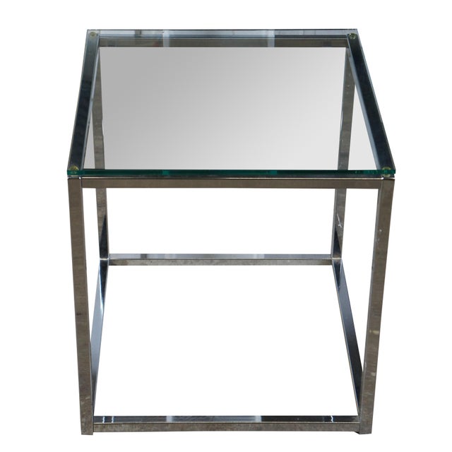 A small modern side table. Features a chrome base with a tempered glass top. Circa 2010. Unsigned Dimensions: 18" x 18" x...