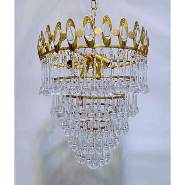 Vintage and restored chandelier with polished gold frame, plain beads and hand blown teardrops. It has 6 candelabra base...