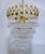 Vintage and restored chandelier with polished gold frame, plain beads and hand blown teardrops. It has 6 candelabra base...