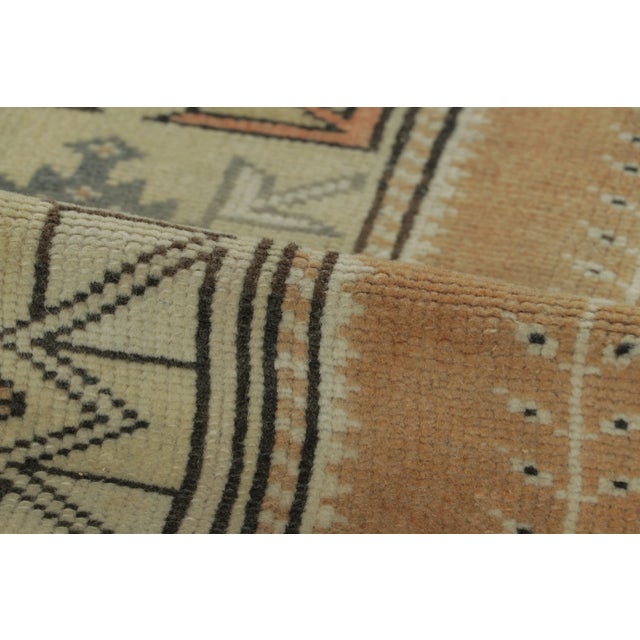 Hand-knotted in wool, this vintage 2x9 Turkish runner rug, circa 1950–1959 features geometric medallions and tribal motifs...