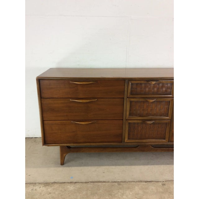 This mid century modern lowboy dresser from Perspective line by Lane Furniture features hardwood construction, walnut...