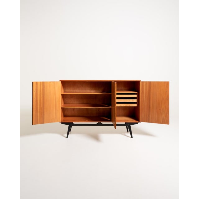 Teak cabinet with three hinged doors, black-stained details, shelves, and removable trays. "Casino" model, Sweden, 1950s....