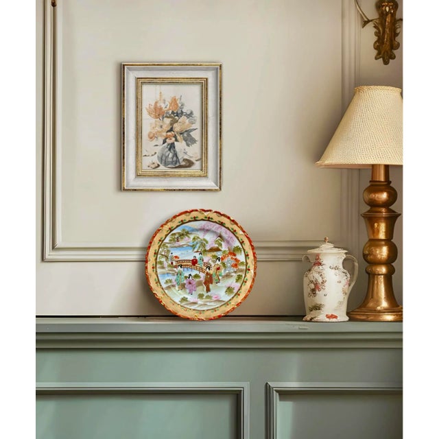 A high-quality Chinese decorative ceramic porcelain plate. The face of the plate is decorated with a hand-painted vignette...