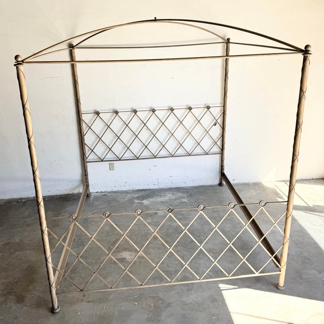 An elegant vintage Hollywood Regency canopy bed crafted in sculptural iron with a warm antiqued finish. The tall posts...